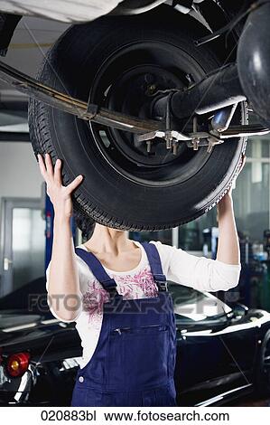 female mechanic changing tire on car View Large Photo Image Stock Image - female mechanic changing tire on car. Fotosearch