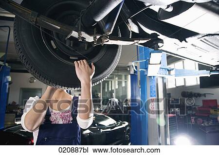 female mechanic changing tire on car View Large Photo Image Stock Image - female mechanic changing tire on car. Fotosearch