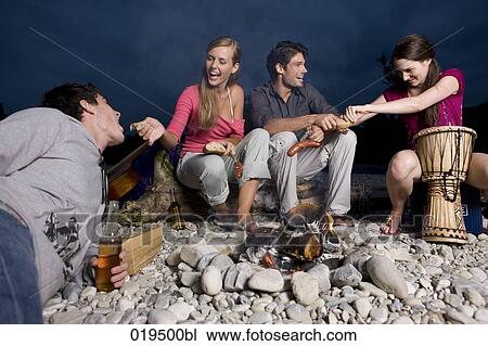 group of friends enjoying beer and sausages on riverbank in summer View Large Photo Image Stock Image - group of friends enjoying beer and sausages on riverbank in summer. Fotosearch