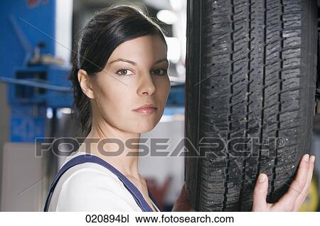 headshot of female mechanic changing tire on car View Large Photo Image Stock Image - headshot of female mechanic changing tire on car. Fotosearch