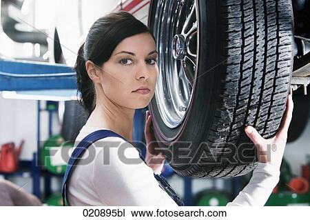 headshot of female mechanic changing tire on car View Large Photo Image Stock Image - headshot of female mechanic changing tire on car. Fotosearch