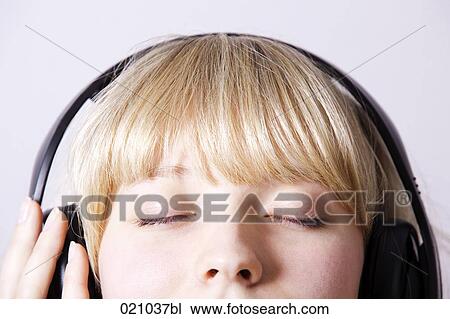 headshot of young woman listening to music with headphones View Large Photo Image Stock Image - headshot of young woman listening to music with headphones. Fotosearch