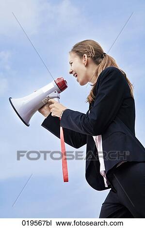 low angle view of young businesswoman shouting through megaphone View Large Photo Image Stock Image - low angle view of young businesswoman shouting through megaphone. Fotosearch