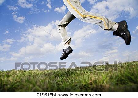 low angle view of young woman jogging in park View Large Photo Image Stock Image - low angle view of young woman jogging in park. Fotosearch