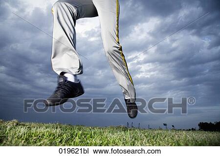 low angle view of young woman jogging in park View Large Photo Image Stock Image - low angle view of young woman jogging in park. Fotosearch