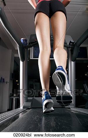 low angle view of young woman exercising on treadmill in gym View Large Photo Image Stock Image - low angle view of young woman exercising on treadmill in gym. Fotosearch