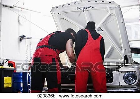 male and female mechanic repairing car engine View Large Photo Image Stock Image - male and female mechanic repairing car engine. Fotosearch