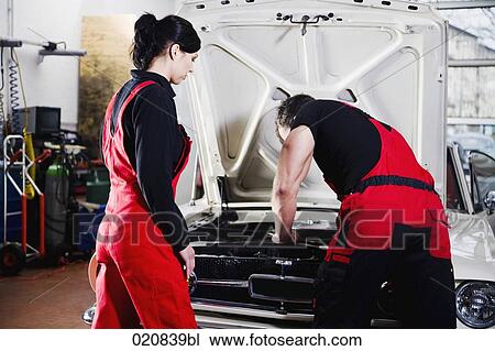 male and female mechanic repairing car engine View Large Photo Image Stock Image - male and female mechanic repairing car engine. Fotosearch