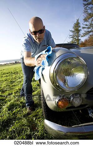 man polishing his classic car with cloth View Large Photo Image Stock Image - man polishing his classic car with cloth. Fotosearch