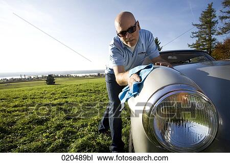 man polishing his classic car with cloth View Large Photo Image Stock Image - man polishing his classic car with cloth. Fotosearch