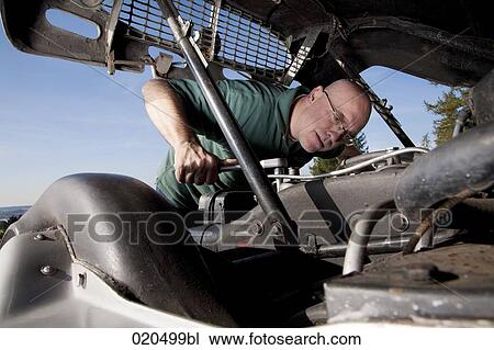 man repairing the engine of his classic car View Large Photo Image Stock Image - man repairing the engine of his classic car. Fotosearch