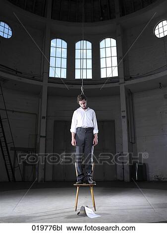 man standing on chair in empty building ready to hang himself View Large Photo Image Stock Image - man standing on chair in empty building ready to hang himself. Fotosearch
