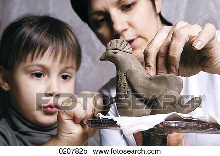 mother and daughter forming sculpture out of clay together View Large Photo Image Stock Image - mother and daughter forming sculpture out of clay together. Fotosearch