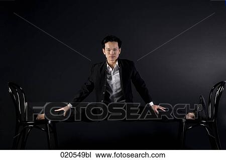 portrait of asian man doing the splits on two chairs View Large Photo Image Stock Image - portrait of asian man doing the splits on two chairs. Fotosearch