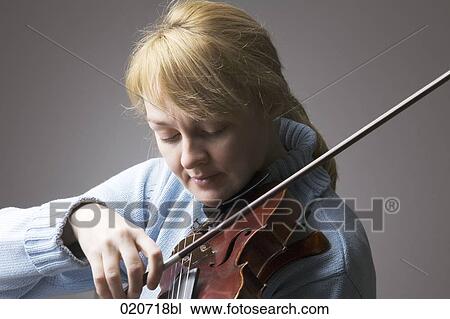 portrait of blond woman playing violin View Large Photo Image Stock Image - portrait of blond woman playing violin. Fotosearch