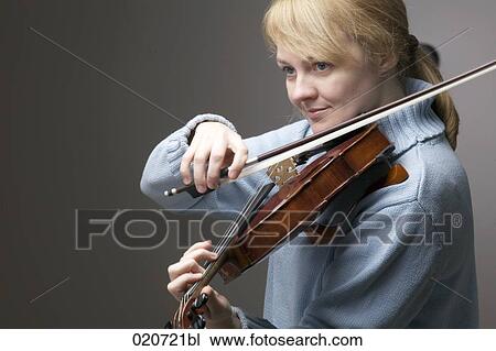 portrait of blond woman playing violin View Large Photo Image Stock Image - portrait of blond woman playing violin. Fotosearch
