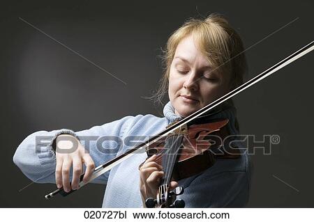 portrait of blond woman playing violin View Large Photo Image Stock Image - portrait of blond woman playing violin. Fotosearch