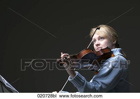 Stock Image - portrait of blond woman playing violin. Fotosearch