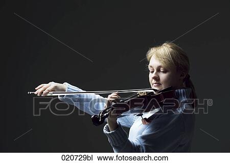Stock Image - portrait of blond woman playing violin. Fotosearch