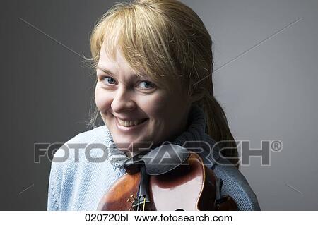 Stock Image - portrait of blond woman with violin. Fotosearch