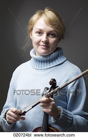 Stock Image - portrait of blond woman with violin. Fotosearch