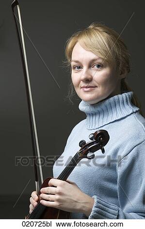 Stock Image - portrait of blond woman with violin. Fotosearch