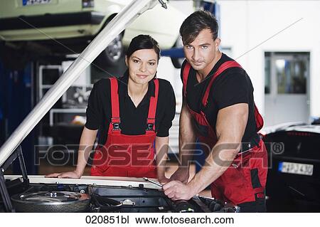 portrait of female and male mechanic repairing car engine View Large Photo Image Stock Image - portrait of female and male mechanic repairing car engine. Fotosearch