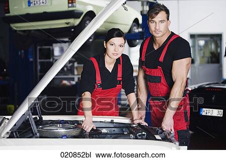 portrait of female and male mechanic repairing car engine View Large Photo Image Stock Image - portrait of female and male mechanic repairing car engine. Fotosearch
