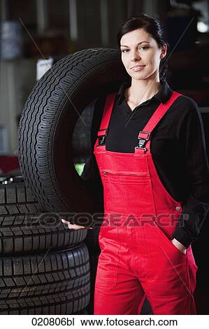 portrait of female mechanic carrying tire View Large Photo Image Stock Image - portrait of female mechanic carrying tire. Fotosearch