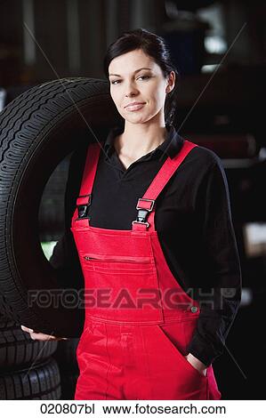 portrait of female mechanic carrying tire View Large Photo Image Stock Image - portrait of female mechanic carrying tire. Fotosearch