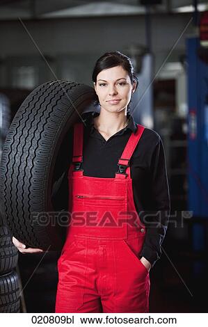 portrait of female mechanic carrying tire View Large Photo Image Stock Image - portrait of female mechanic carrying tire. Fotosearch