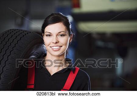 portrait of female mechanic carrying tire View Large Photo Image Stock Image - portrait of female mechanic carrying tire. Fotosearch
