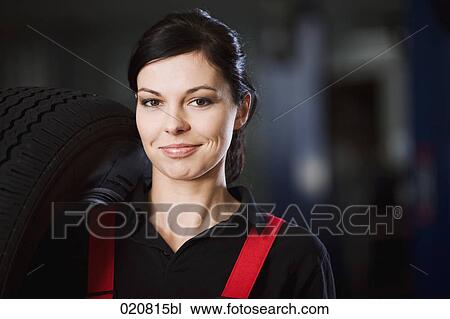 portrait of female mechanic carrying tire View Large Photo Image Stock Image - portrait of female mechanic carrying tire. Fotosearch