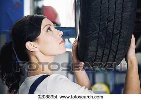portrait of female mechanic changing tire on car View Large Photo Image Stock Image - portrait of female mechanic changing tire on car. Fotosearch