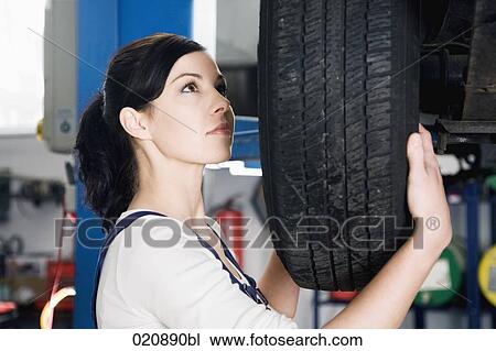portrait of female mechanic changing tire on car View Large Photo Image Stock Image - portrait of female mechanic changing tire on car. Fotosearch