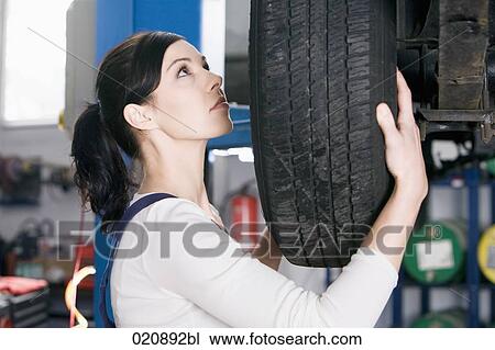 portrait of female mechanic changing tire on car View Large Photo Image Stock Image - portrait of female mechanic changing tire on car. Fotosearch