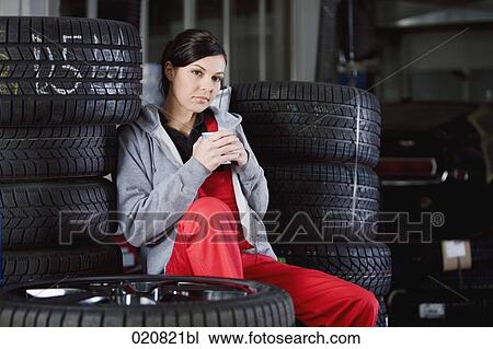 portrait of female mechanic having coffee break in garage View Large Photo Image Stock Image - portrait of female mechanic having coffee break in garage. Fotosearch
