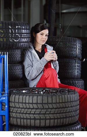 portrait of female mechanic having coffee break in garage View Large Photo Image Stock Image - portrait of female mechanic having coffee break in garage. Fotosearch