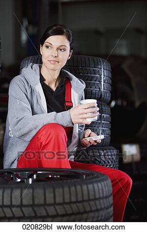 portrait of female mechanic having coffee break in garage View Large Photo Image Stock Image - portrait of female mechanic having coffee break in garage. Fotosearch