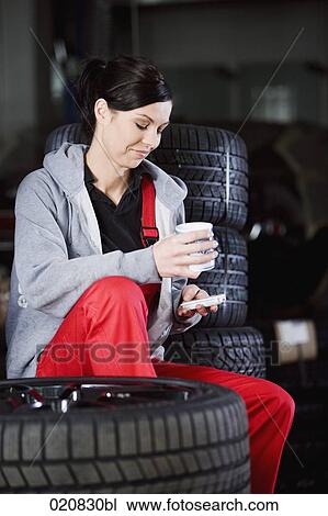 portrait of female mechanic having coffee break in garage View Large Photo Image Stock Image - portrait of female mechanic having coffee break in garage. Fotosearch