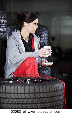 portrait of female mechanic having coffee break in garage View Large Photo Image Stock Image - portrait of female mechanic having coffee break in garage. Fotosearch