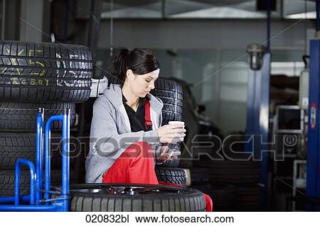 portrait of female mechanic having coffee break in garage View Large Photo Image Stock Image - portrait of female mechanic having coffee break in garage. Fotosearch