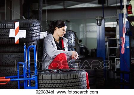 portrait of female mechanic having coffee break in garage View Large Photo Image Stock Image - portrait of female mechanic having coffee break in garage. Fotosearch