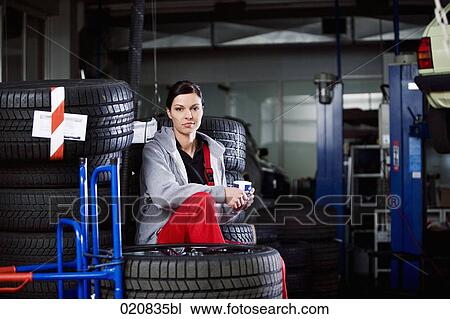 portrait of female mechanic having coffee break in garage View Large Photo Image Stock Image - portrait of female mechanic having coffee break in garage. Fotosearch