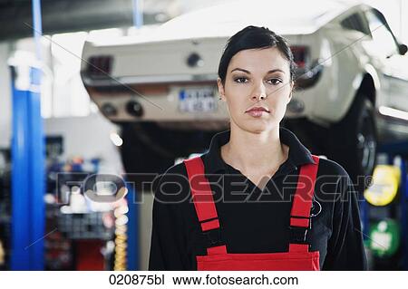 Stock Image - portrait of female mechanic in garage. Fotosearch