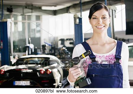 portrait of female mechanic with cordless wrench View Large Photo Image Stock Image - portrait of female mechanic with cordless wrench. Fotosearch