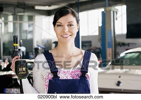 portrait of female mechanic with cordless wrench View Large Photo Image Stock Image - portrait of female mechanic with cordless wrench. Fotosearch
