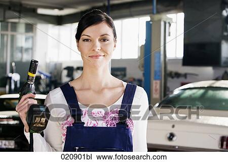 portrait of female mechanic with cordless wrench View Large Photo Image Stock Image - portrait of female mechanic with cordless wrench. Fotosearch