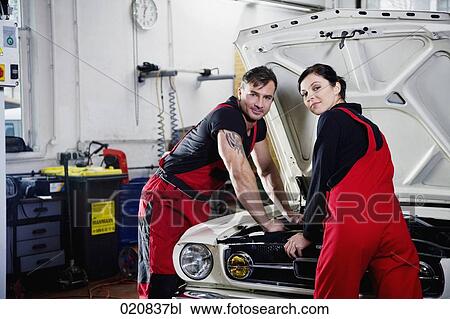 portrait of male and female mechanic repairing car engine View Large Photo Image Stock Image - portrait of male and female mechanic repairing car engine. Fotosearch