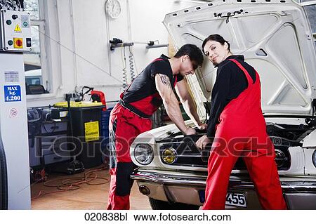 portrait of male and female mechanic repairing car engine View Large Photo Image Stock Image - portrait of male and female mechanic repairing car engine. Fotosearch